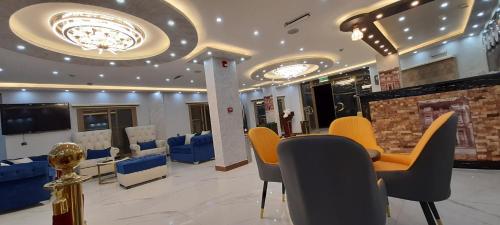 a lobby with a waiting room with chairs and a fireplace at Venus Hotel in Wadi Musa