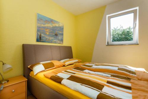 a bedroom with a large bed with a window at Apartments Familie Vujec in Skrbčići