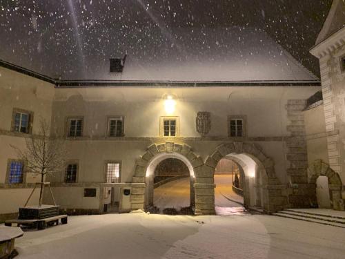 a building with an archway in the snow at Lovely Flat in a Lovely City in Steyr