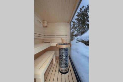 a sauna with snow on the floor of a room at Exklusives Chalet mit traumhafter See- und Bergsicht in Seelisberg