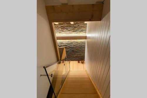a staircase in a house with wooden floors and a ceiling at Exklusives Chalet mit traumhafter See- und Bergsicht in Seelisberg