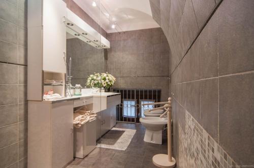 a bathroom with a toilet and a sink at Torino Chic in Turin