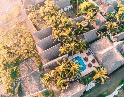 an aerial view of a resort with palm trees at Paredon Surf House in El Paredón Buena Vista