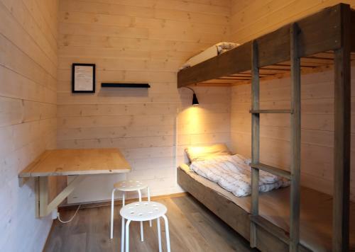 a bedroom with a bunk bed and a desk at Trolltunga Camping in Odda