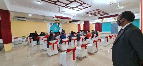 a group of people sitting in chairs in a room at Nook Inn & Suites - MG ROAD METRO in Gurgaon