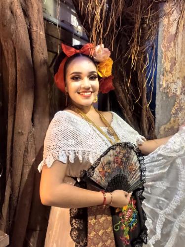 a woman in a dress holding a fan at Chuchumbé Hotel & Hostal in Veracruz