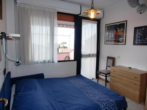 a bedroom with a blue bed and a window at Ammiraglio in Campese