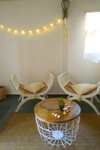 a room with three chairs and a table at The Village Anjuna in Anjuna