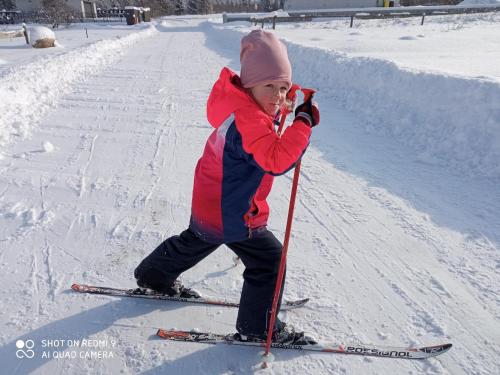 a young child on skis in the snow at Apartmán Elenka in Zuberec