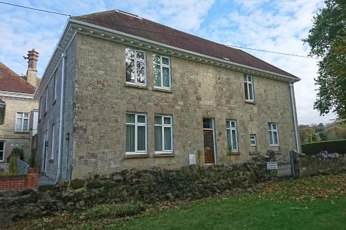 an old brick house with a stone wall at Shanklin Manor in Shanklin