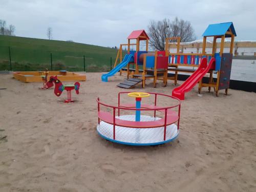 a playground with many different types of play equipment at Domek Mikołajki in Mikołajki