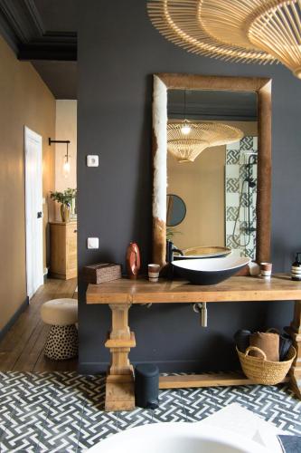 a bathroom with a large mirror and a sink at Villa Louisa in Saint Malo