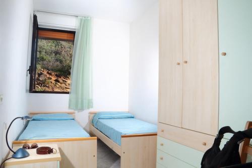 a small bedroom with two beds and a window at Ammiraglio in Campese