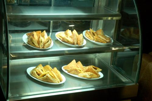 a display case with several plates of food on plates at Hotel JIVA in Jamshedpur