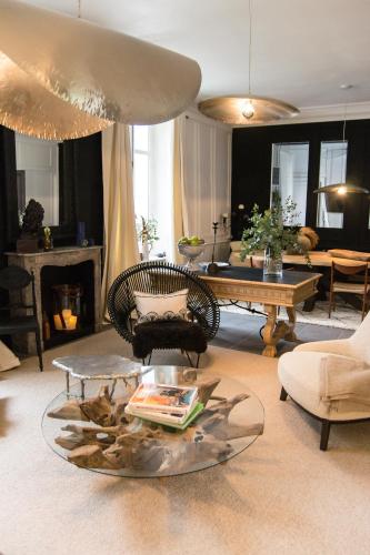 a living room with a chair and a table at Villa Louisa in Saint Malo