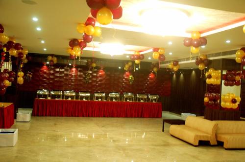a banquet hall with balloons and a table with chairs at Hotel JIVA in Jamshedpur