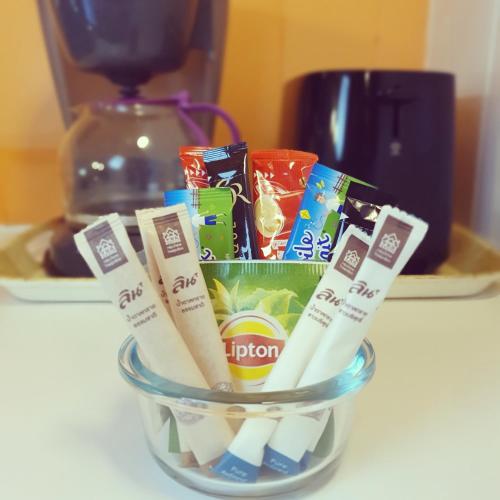 a glass bowl filled with toothbrushes and candy at Fare Tokoau Moorea in Moorea