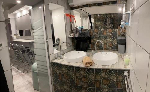 a bathroom with two sinks on a counter at Marilyn City Center in Pécs