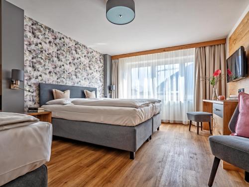 Posteľ alebo postele v izbe v ubytovaní Stadthotel EGGERBRÄU