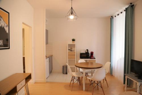 a dining room and kitchen with a table and chairs at Maison Candela in Argelès-Gazost
