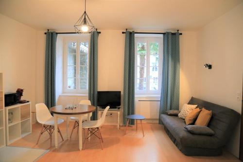 a living room with a couch and a table at Maison Candela in Argelès-Gazost