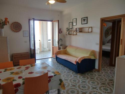 a living room with a bed and a dining room table at Ammiraglio in Campese
