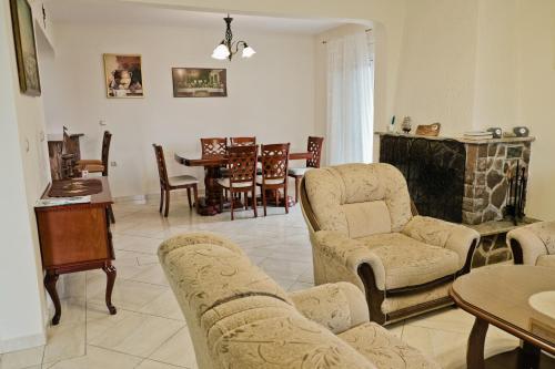 a living room with a couch and chairs and a table at Apartments Klara in Utjeha
