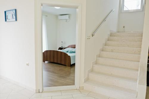 a hallway with stairs leading to a bedroom at Apartments Klara in Utjeha