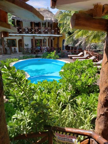 a swimming pool in front of a house at Casa Hridaya Hotel Boutique in Holbox Island