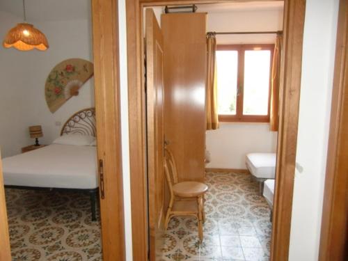a room with a bed and a chair and a window at Ammiraglio in Campese