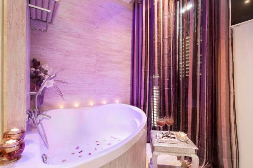 a bathroom with a tub with lights in it at Romantic Barcelona Apartment in Barcelona