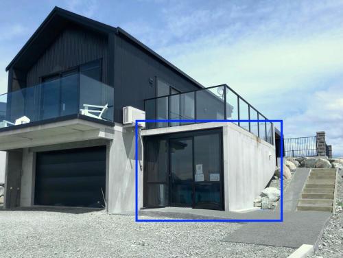 a black house with blue parts of it at GALAXY LAKE VIEW STUDIO in Lake Tekapo