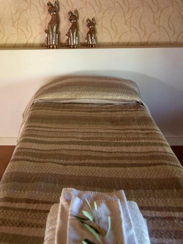 a bed with a blanket and some figurines on it at Agriturismo Il Solengo in Cretone