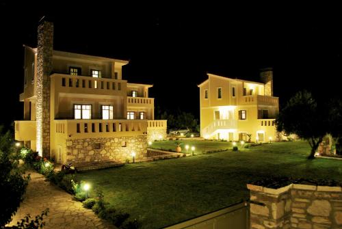 a large house at night with lights in the yard at Elaia Villas in Pythagoreio