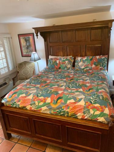 a bedroom with a bed with a colorful comforter at Chantico Inn in Ojai