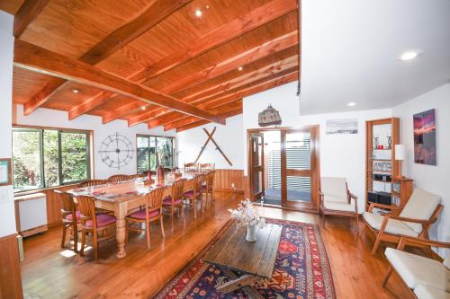 - une salle à manger avec une table et des chaises en bois dans l'établissement Te Wanaka Lodge, à Wanaka