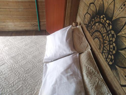 
an unmade bed in a room with a wooden floor at Nuestra Cabañita in Playa Blanca
