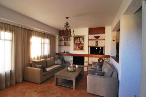 a living room with two couches and a table at Elaia Villas in Pythagoreio