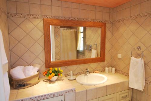 a bathroom with a sink and a mirror at Elaia Villas in Pythagoreio