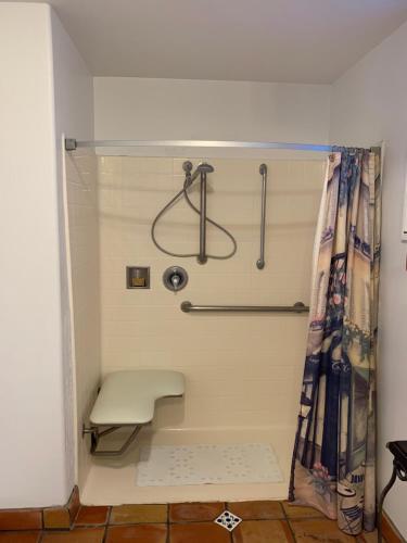 a shower stall with a bench in a bathroom at Chantico Inn in Ojai