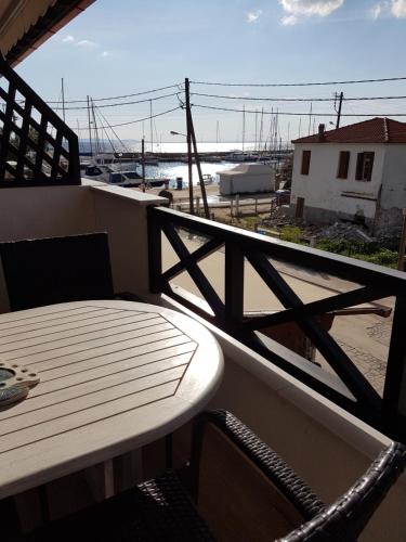 a balcony with a table and a view of a harbor at Marina in Nikiti