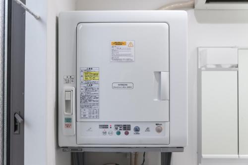a white microwave oven in a room at nestay inn tokyo senju in Tokyo