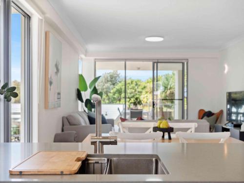 a living room filled with furniture and a large window at Pacific Marina Apartments in Coffs Harbour
