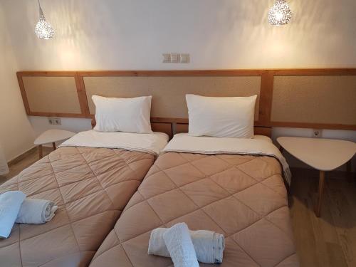 a bedroom with two beds with towels on them at Marina in Nikiti