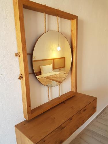 a mirror on a shelf with a bed in a room at Marina in Nikiti