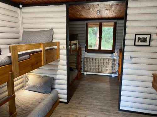 a room with two bunk beds and a window at River Run Lodge in Strathblane