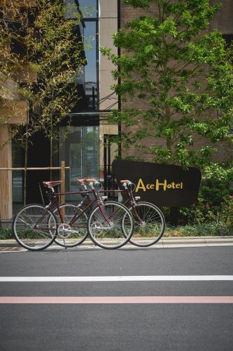 three bikes parked on the side of a street at Ace Hotel Kyoto in Kyoto