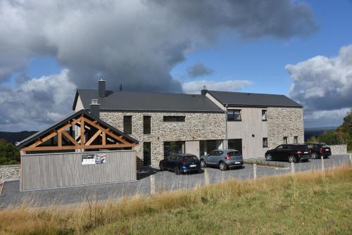 a large house with cars parked in front of it at Rochehaut, Les Semoiselles, Villa Isabelle in Bouillon