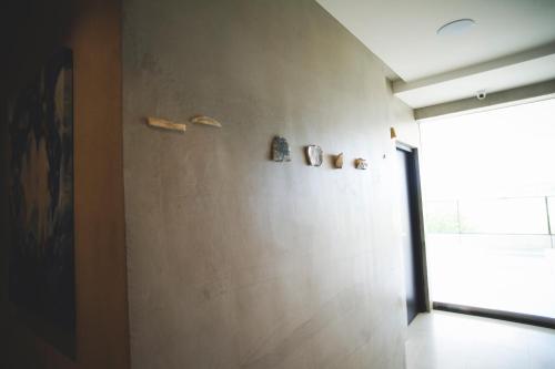 a room with a wall with sculptures on it at FFF Hotel in Hengchun