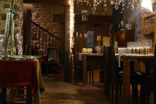 a dining room with tables and chairs and a chandelier at Monegal in Sant Llorenc de Morunys